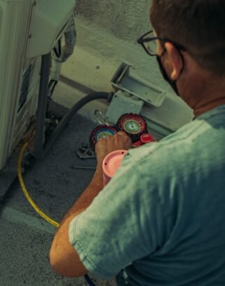 QR Corporation technician installing an air conditioning unit